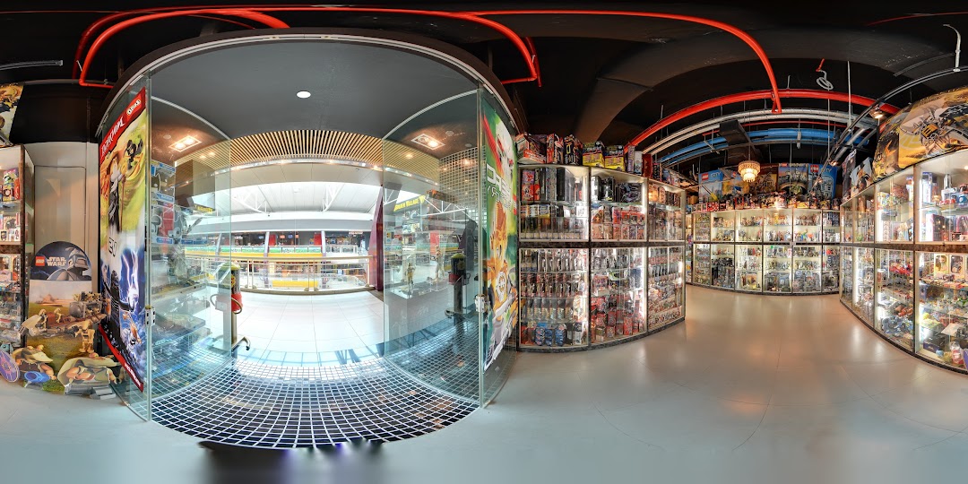 Interior view of Simply Toys, showcasing extensive display cases filled with action figures, collectibles, and toys.
