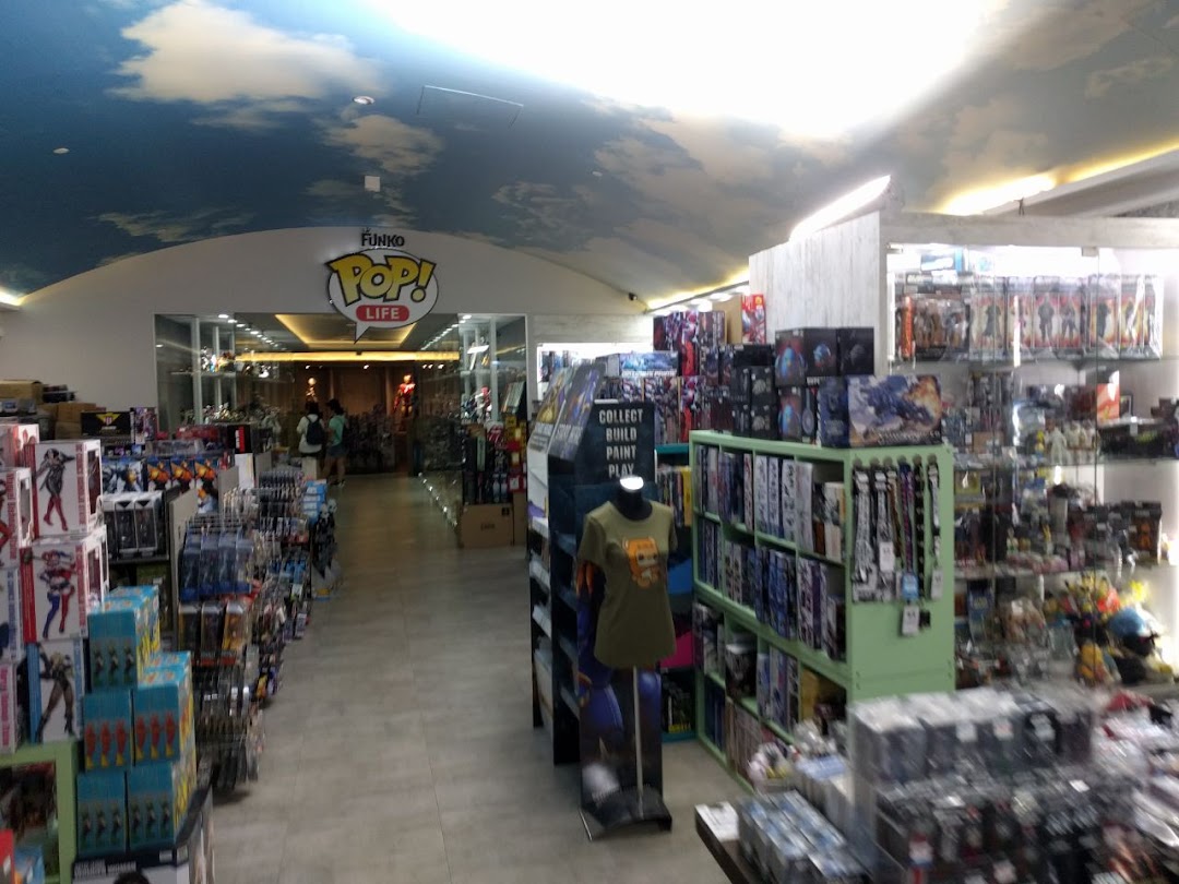 An interior view of Simply Toys, showcasing aisles filled with collectibles and a Funko Pop! Life entrance.