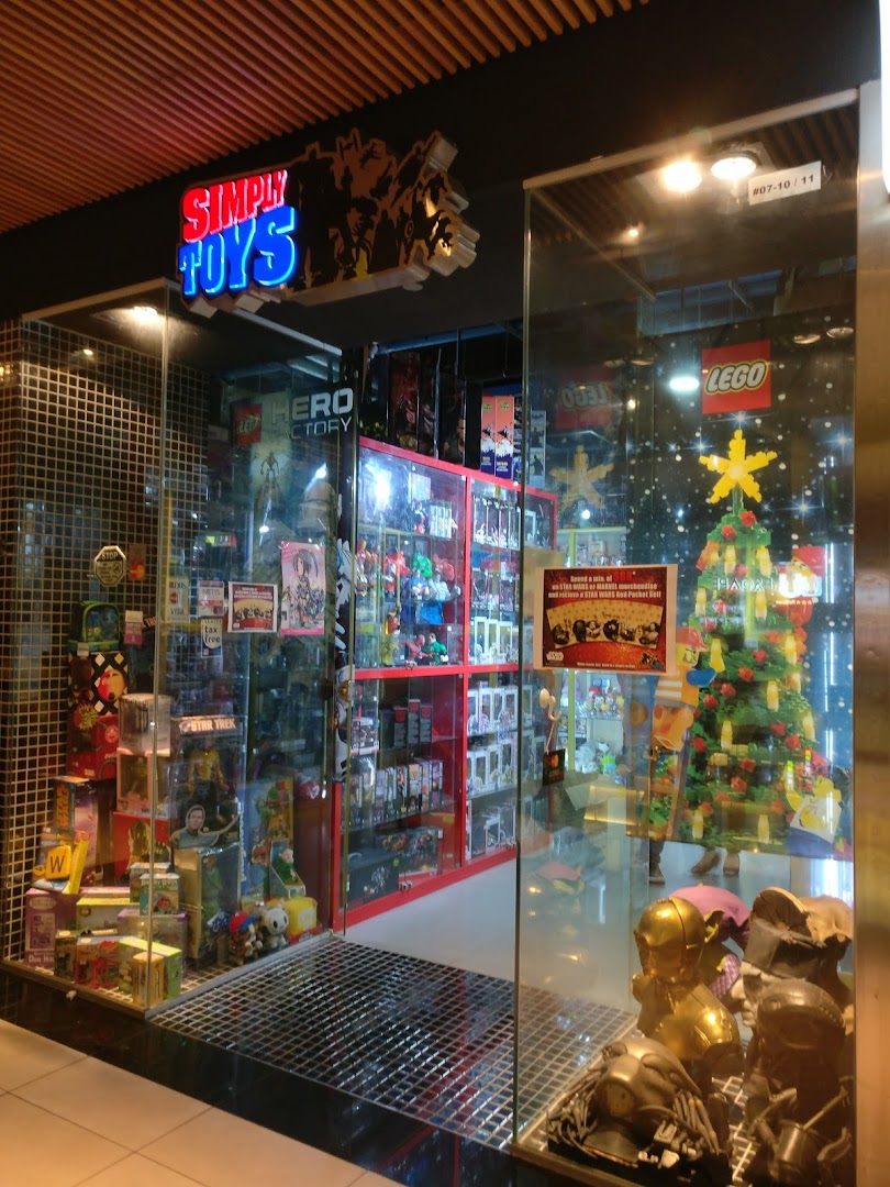 Brightly lit shop front of 'Simply Toys' showcasing a wide array of toys and pop culture collectibles.
