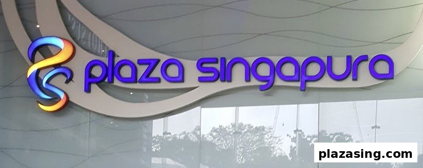 Close-up of the illuminated 'Plaza Singapura' mall logo and name.