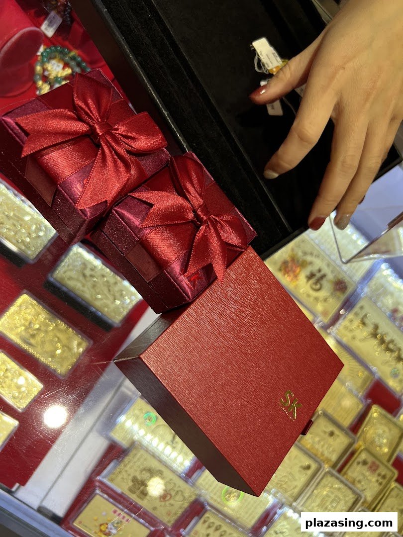 Elegant red gift boxes with bows, showcasing jewellery packaging and gold items at SK Jewellery.
