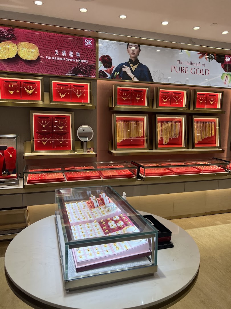 Interior view of SK Jewellery showcasing gold displays, necklaces, and promotional banners.