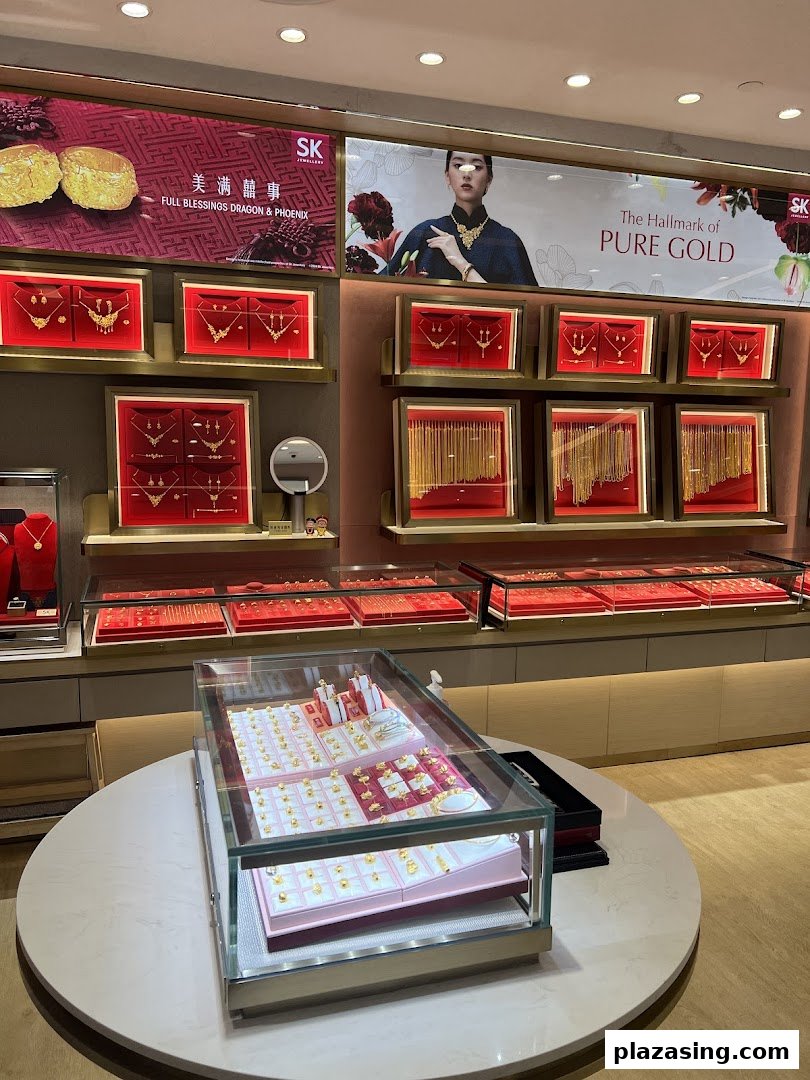 Interior view of SK Jewellery showcasing gold displays, necklaces, and promotional banners.