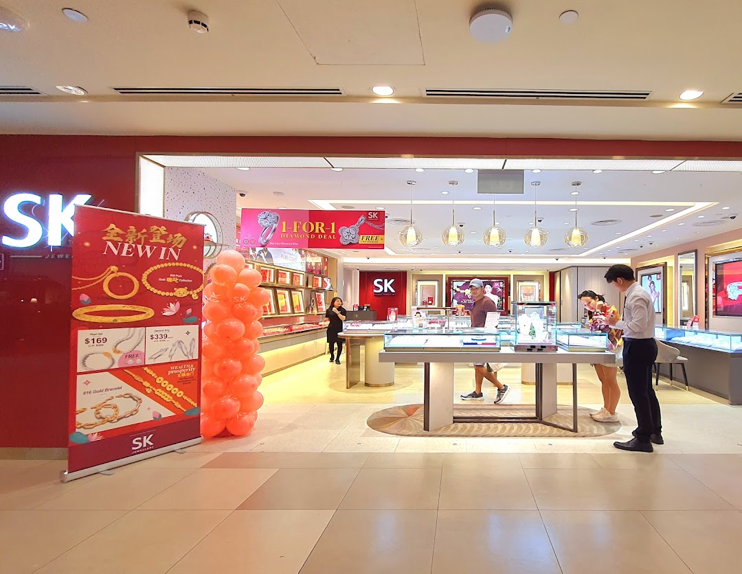 The inviting entrance of SK Jewellery, showcasing its bright interior, display cases, and promotional banners.