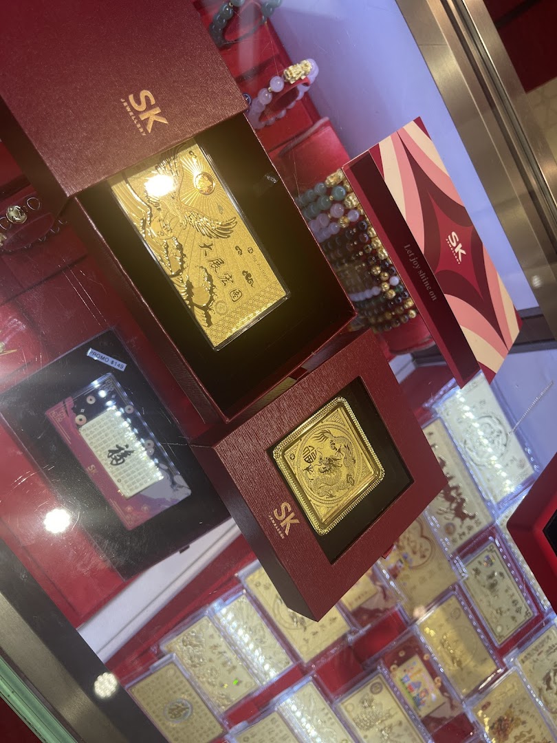 Close-up of intricate gold-plated items and bracelets displayed in a jewellery store.