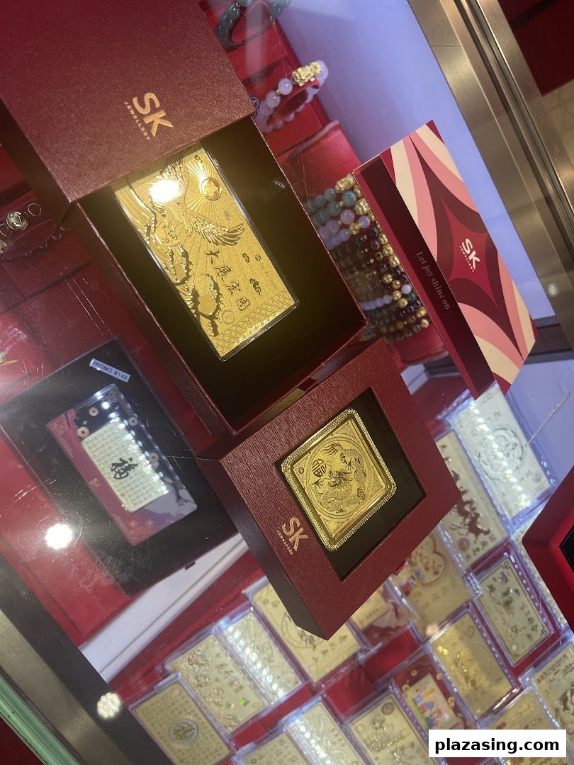 Close-up of intricate gold-plated items and bracelets displayed in a jewellery store.