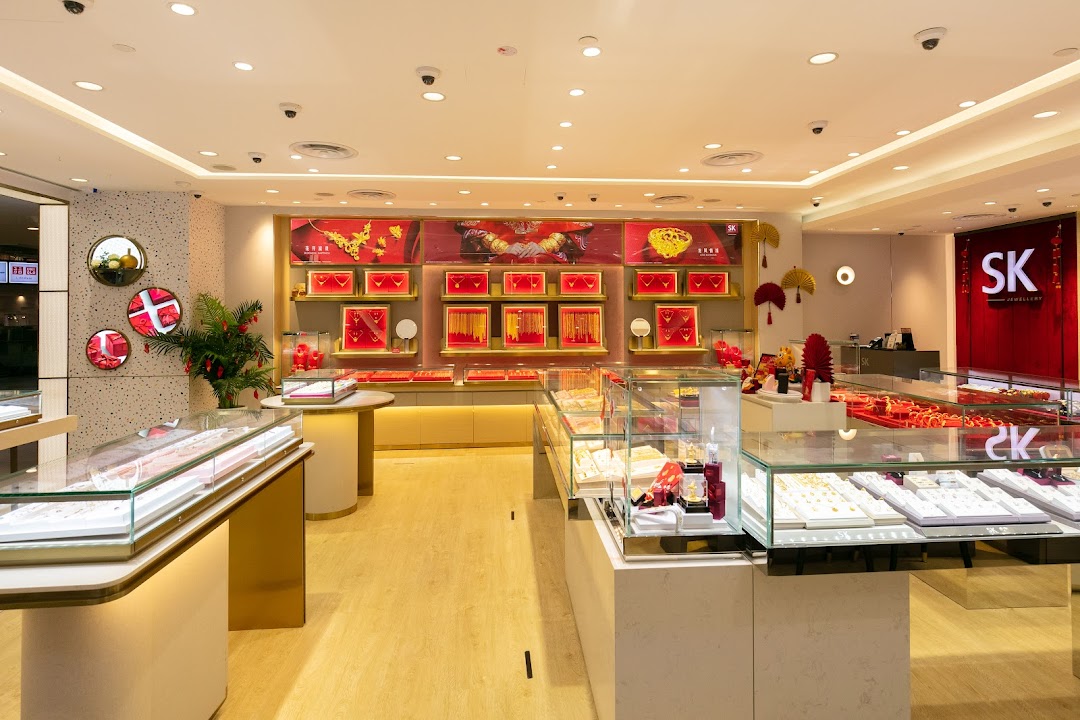 An interior view of SK Jewellery, showcasing brightly lit display cases filled with gold and diamond pieces.