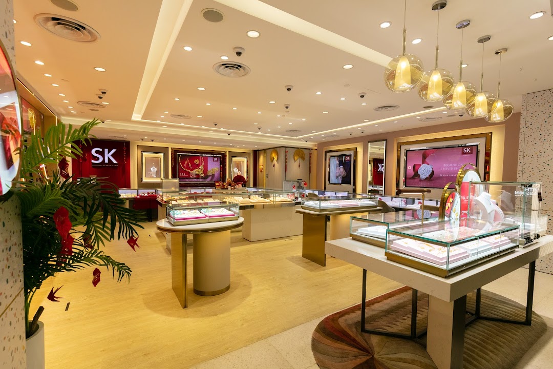 Interior view of SK Jewellery, showcasing elegant display cases filled with exquisite jewelry and digital marketing screens.