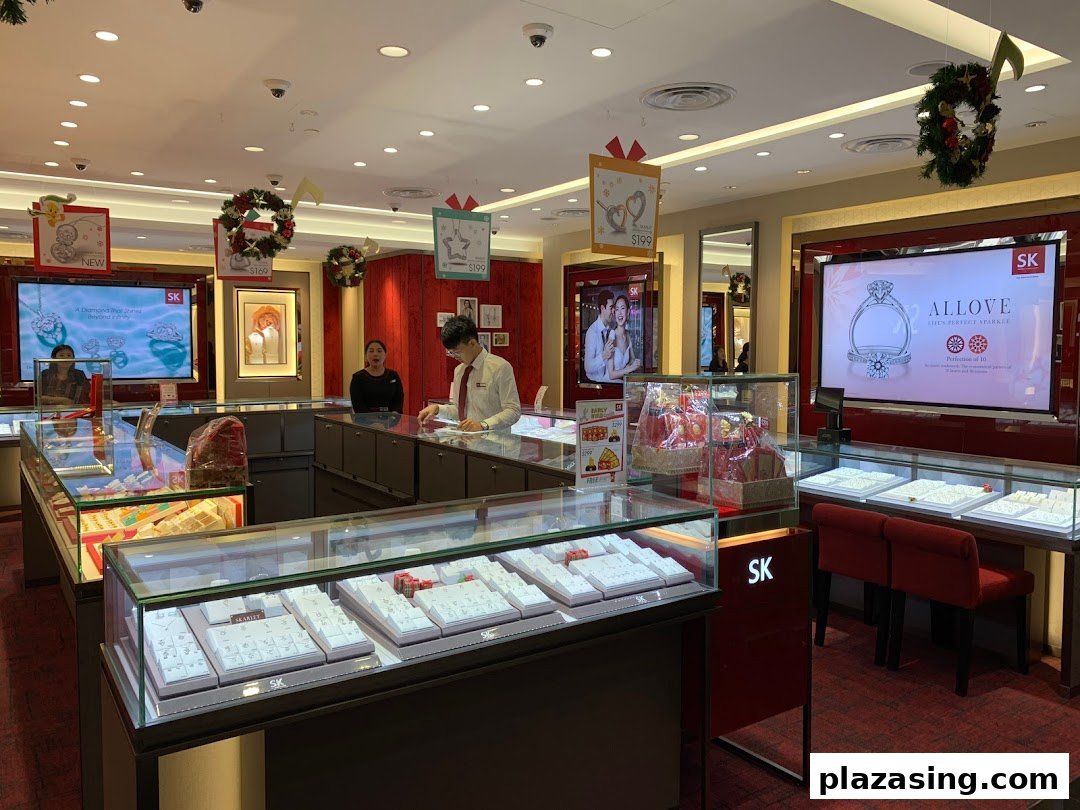 An interior view of SK Jewellery, showcasing sparkling display cases, digital screens, and attentive staff.