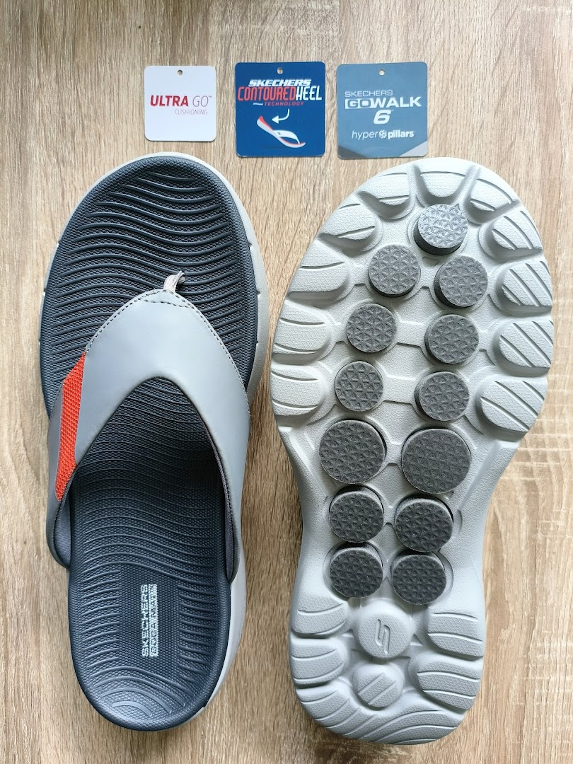 A pair of Skechers sandals with product tags highlighting comfort technologies like ULTRA GO and Hyper Pillars.