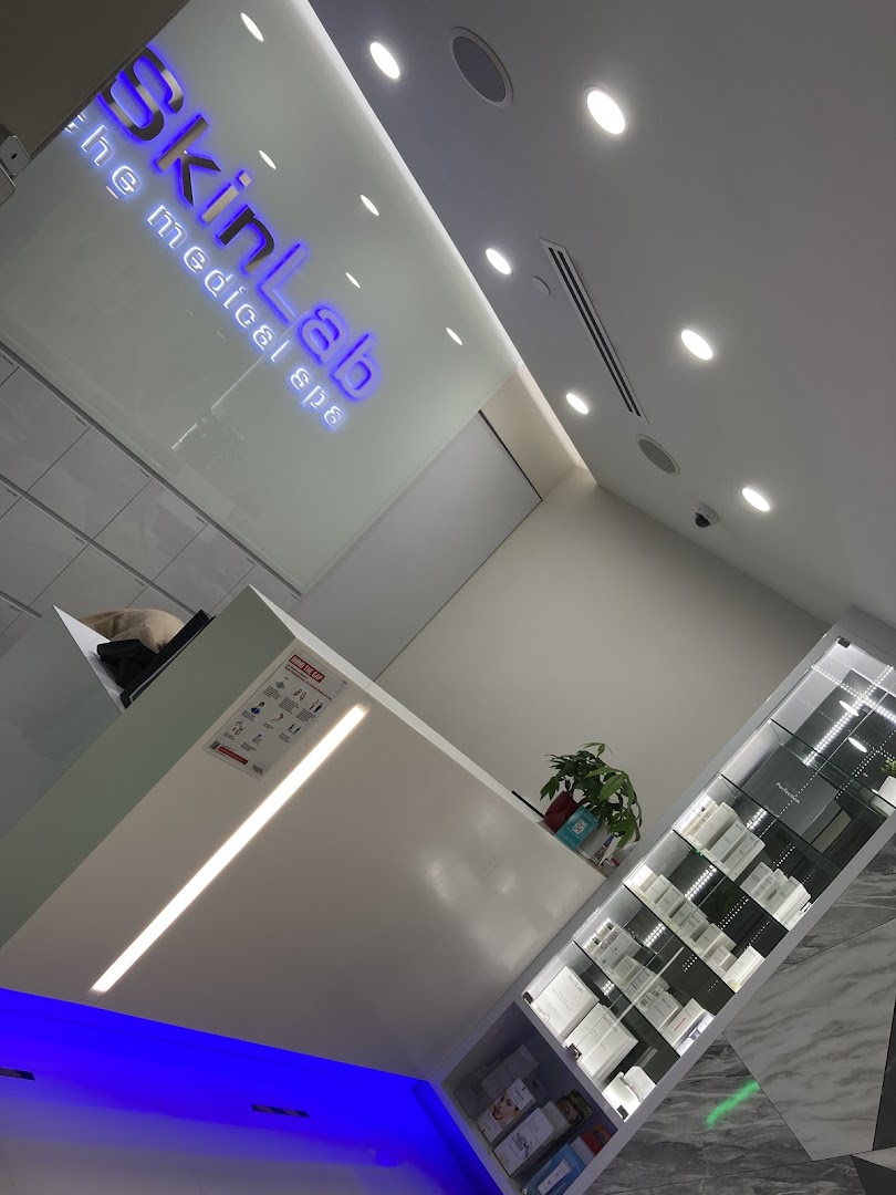 The reception area of SkinLab The Medical Spa, featuring its illuminated logo and product displays.