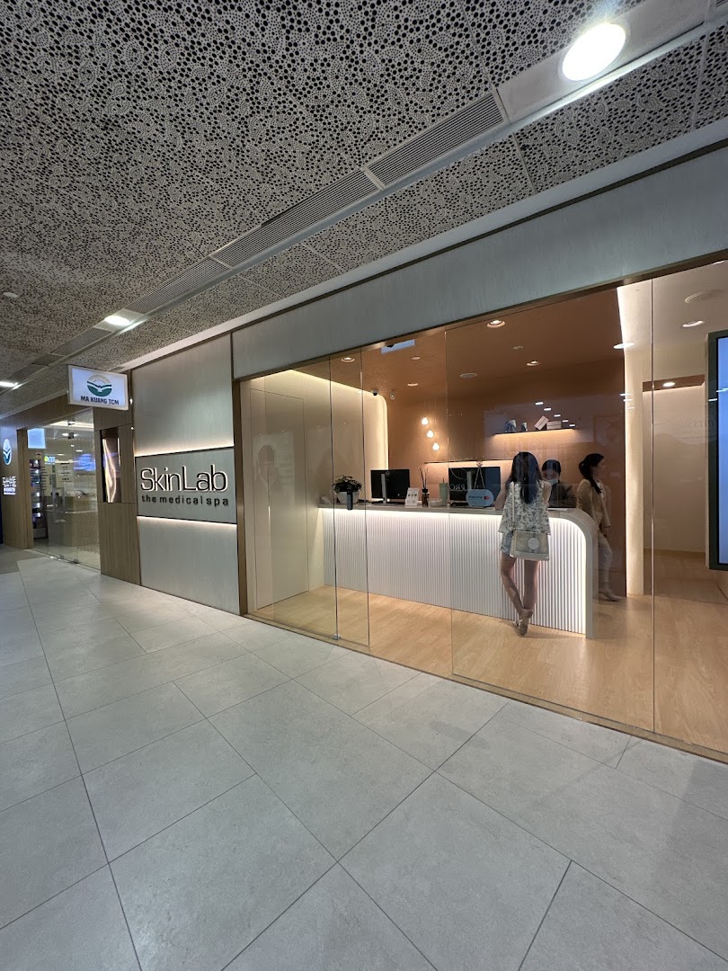The modern glass storefront of SkinLab The Medical Spa, featuring a bright reception area and inviting interior.