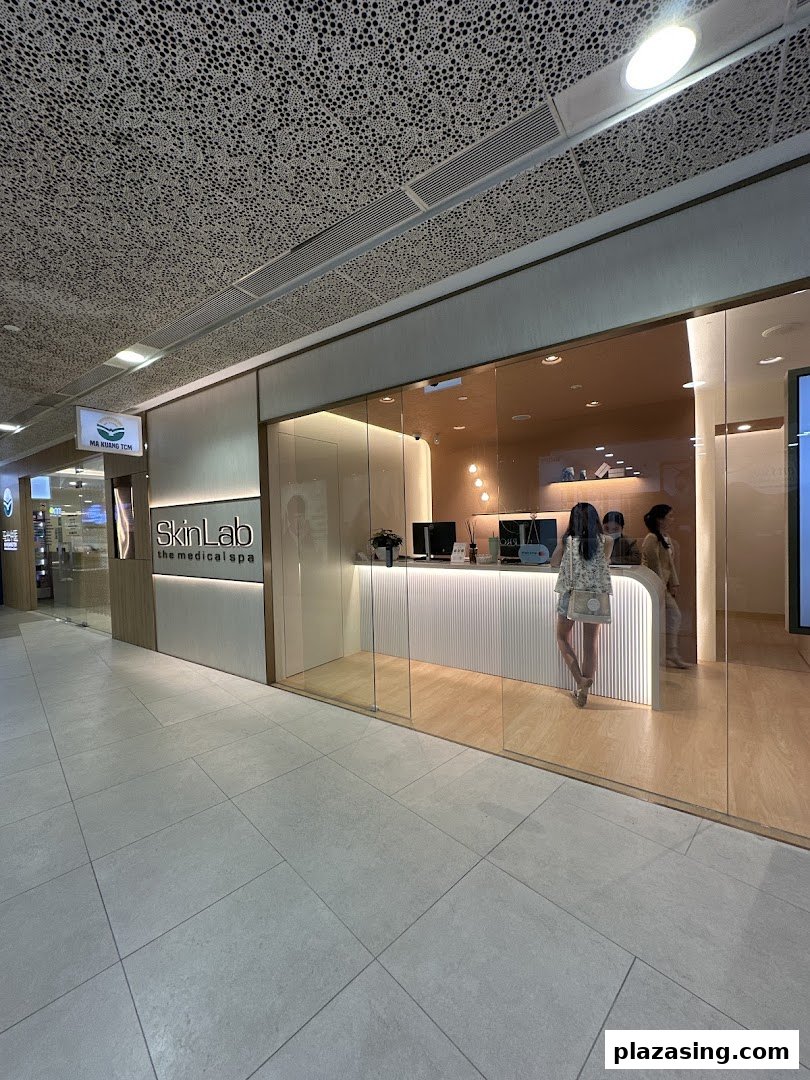 The modern glass storefront of SkinLab The Medical Spa, featuring a bright reception area and inviting interior.