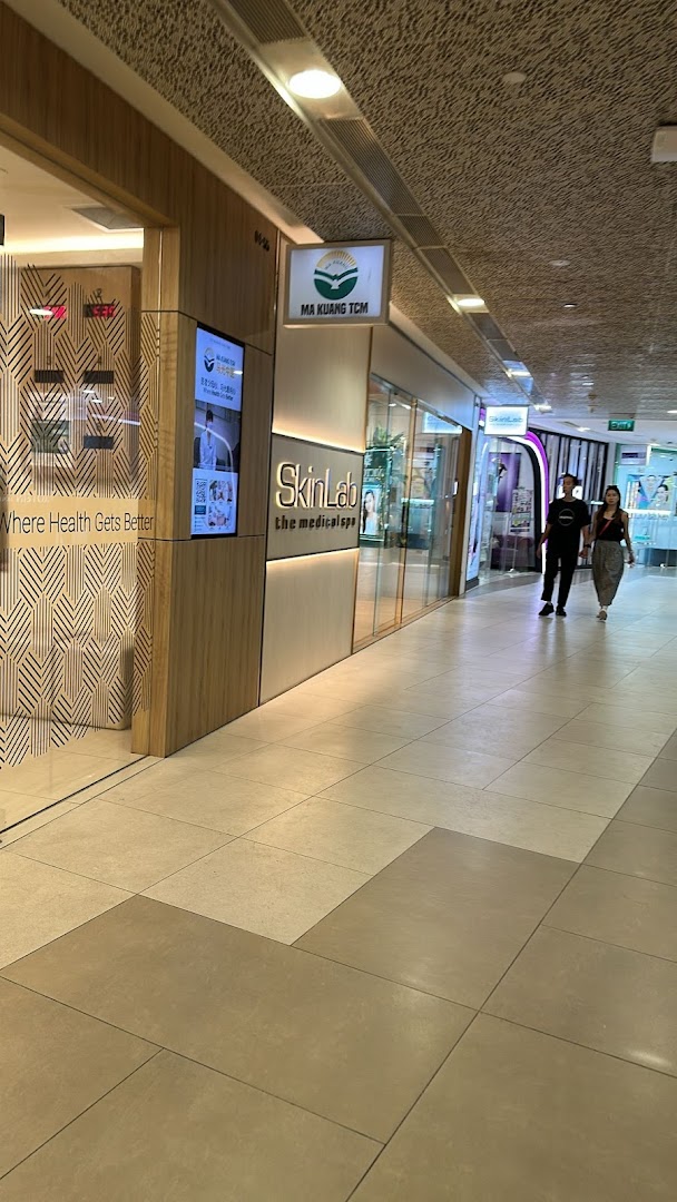 Exterior view of SkinLab The Medical Spa and Ma Kuang TCM in a shopping mall corridor.