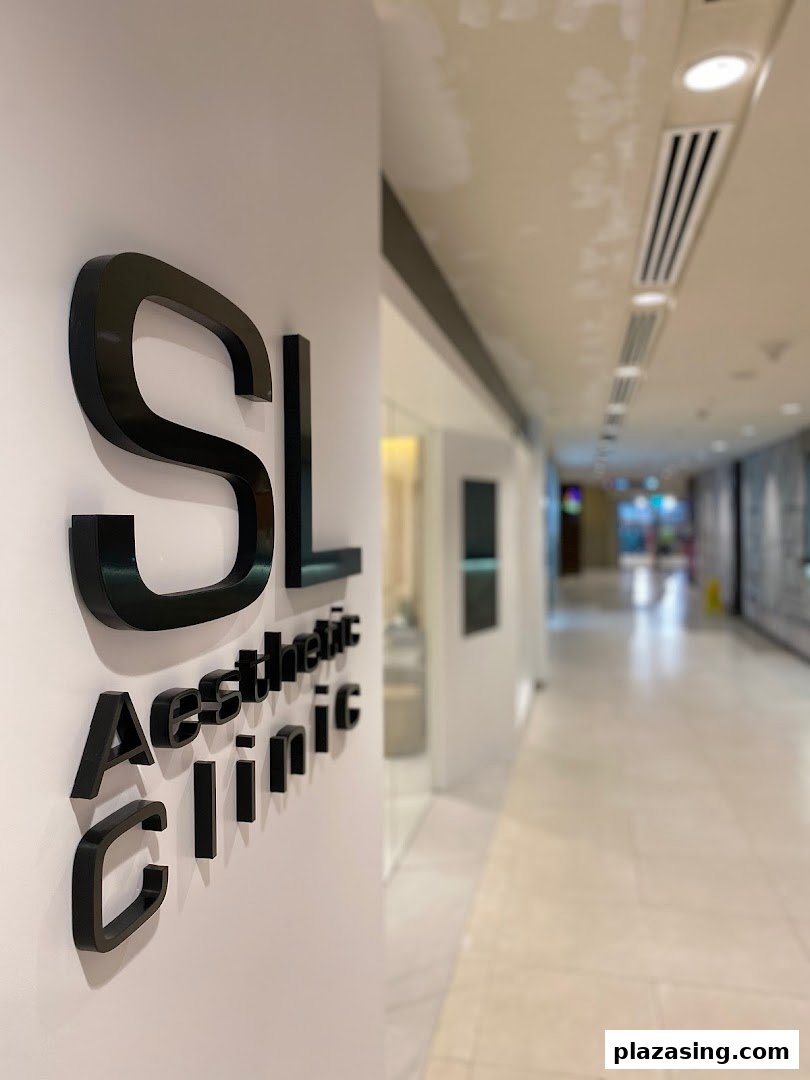 The SL Aesthetic Clinic sign prominently displayed on a wall in a modern mall corridor.