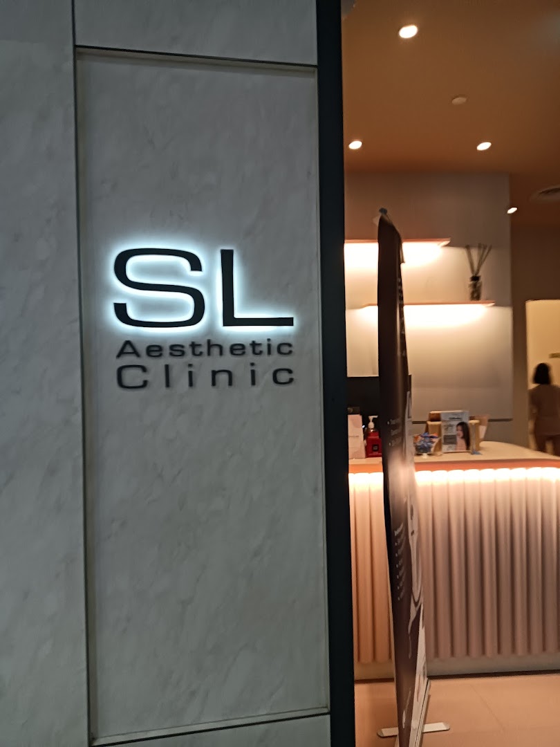 Illuminated 'SL Aesthetic Clinic' sign at the entrance, with a glimpse of the interior.