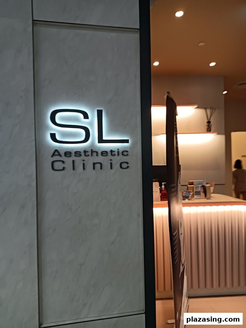 Illuminated 'SL Aesthetic Clinic' sign at the entrance, with a glimpse of the interior.