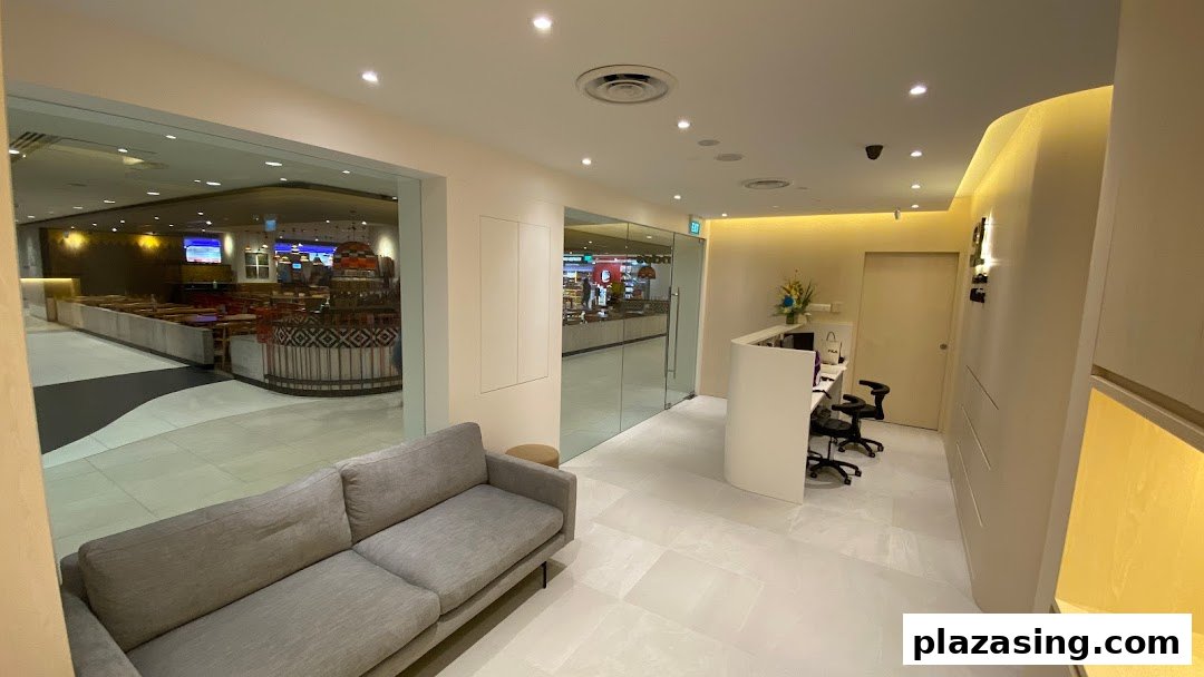 A modern and inviting waiting area with a comfortable sofa and reception desk at SL Aesthetic Clinic.