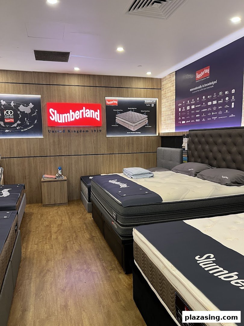 Interior view of a Slumberland bedding store showcasing various mattresses and bed frames.