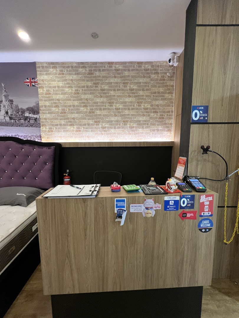 Interior view of a Slumberland bedding store, showing a reception counter and a mattress display.