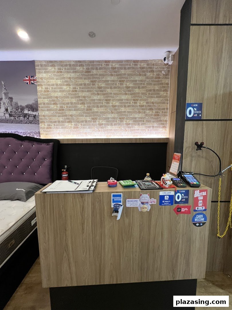 Interior view of a Slumberland bedding store, showing a reception counter and a mattress display.