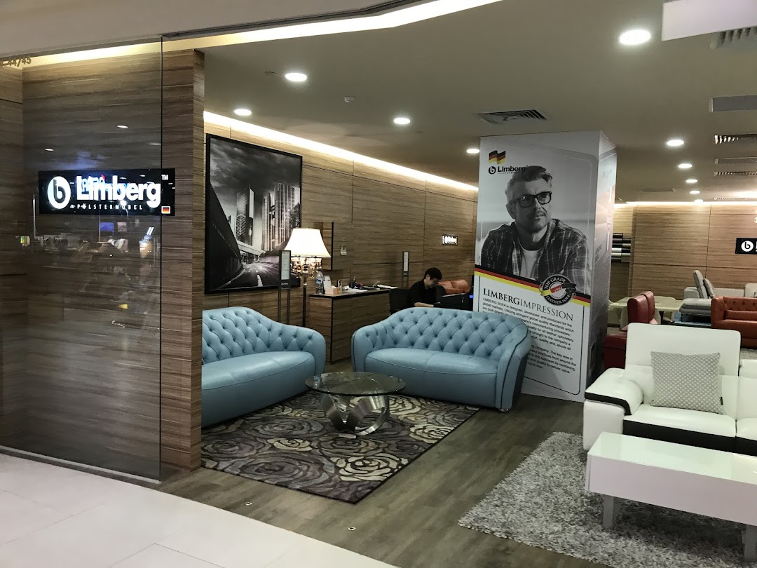 An interior view of a modern furniture showroom featuring stylish sofas and home decor.