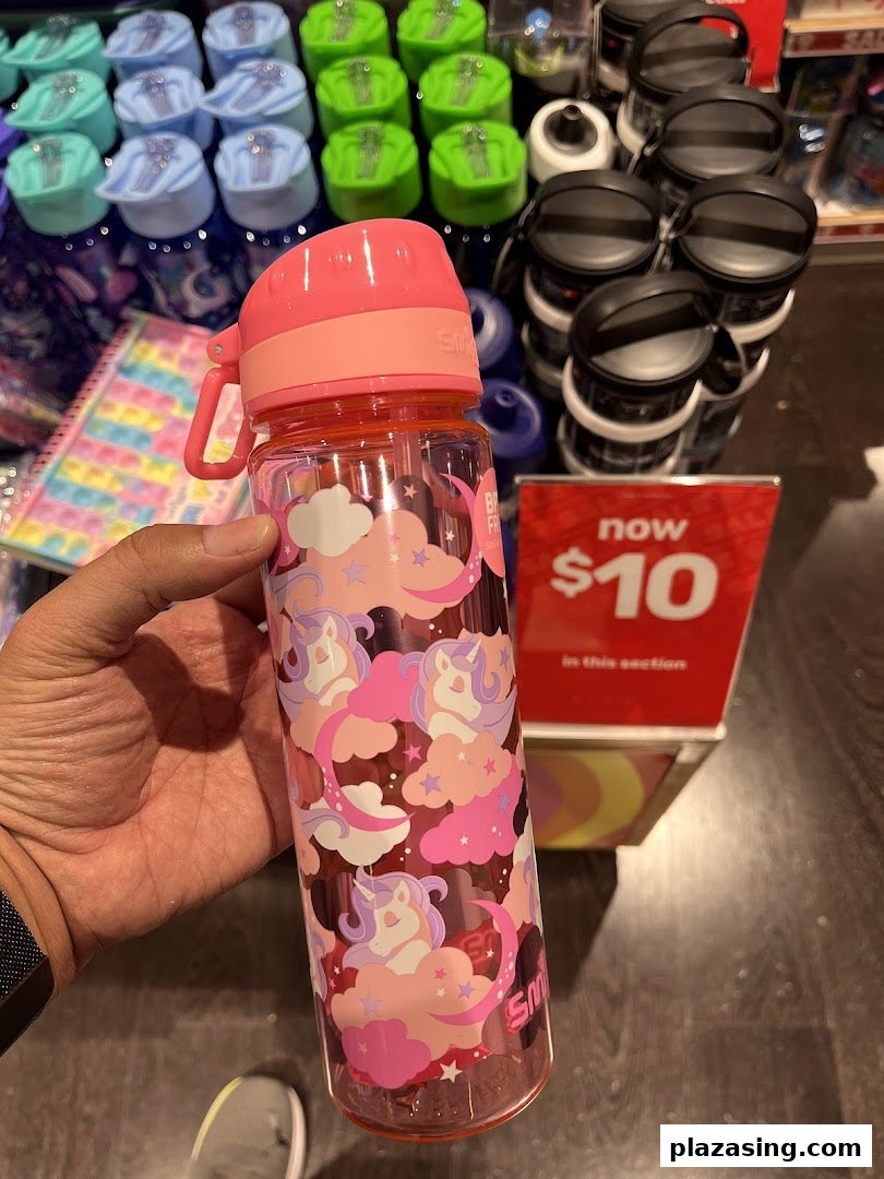A hand holds a pink unicorn-themed Smiggle water bottle, with other colorful bottles and a '$10' sale sign.