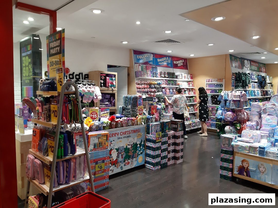 Interior view of Smiggle store showcasing colorful stationery, bags, and gifts, with customers browsing.