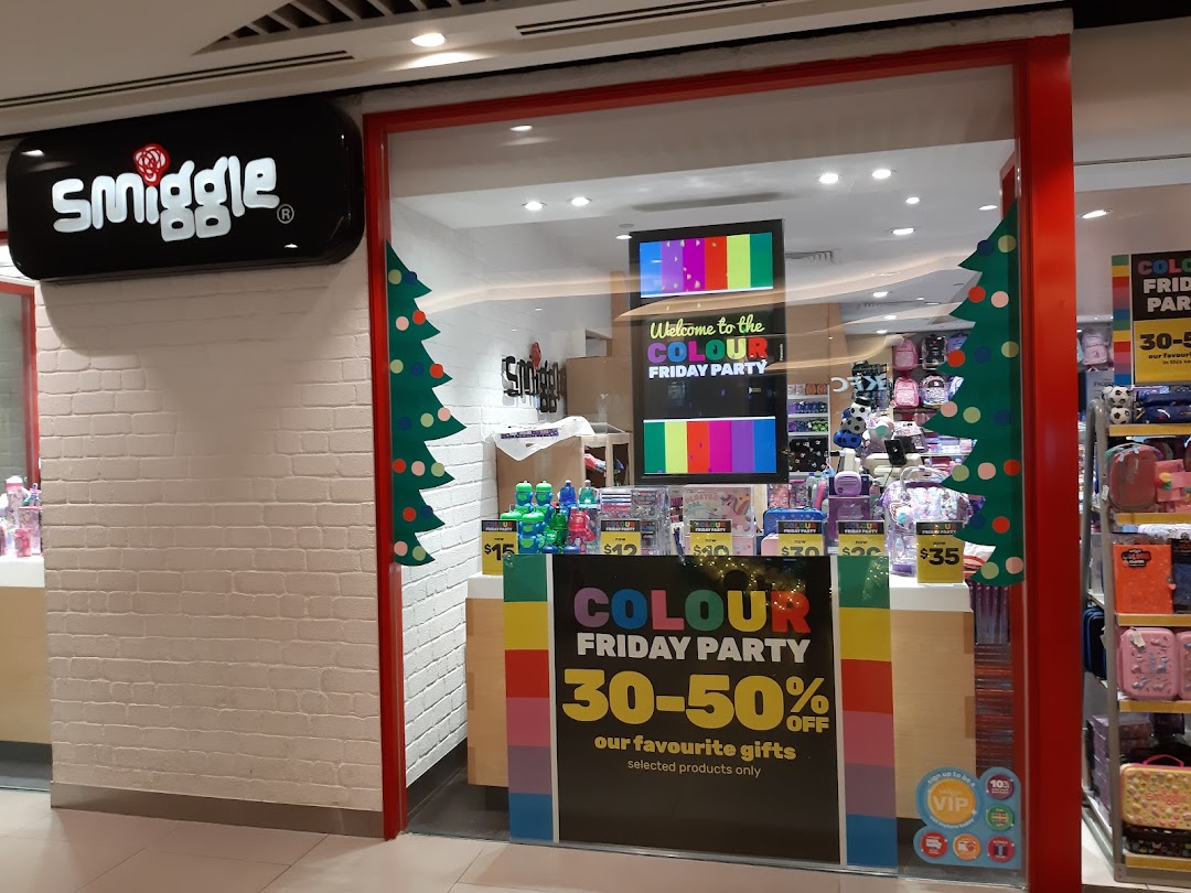 Exterior view of the Smiggle shop with colorful window displays and festive holiday decorations.