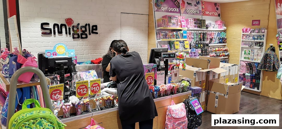 Interior view of a Smiggle store with a staff member at the counter and colorful stationery products.