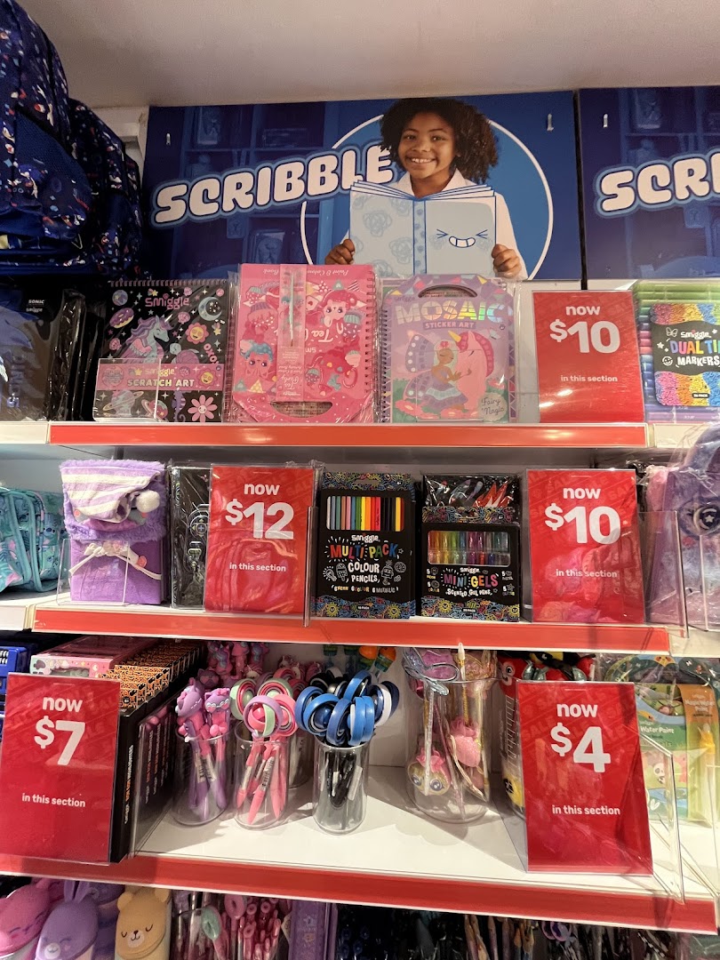 Colorful Smiggle stationery and art supplies displayed on shelves with promotional pricing.