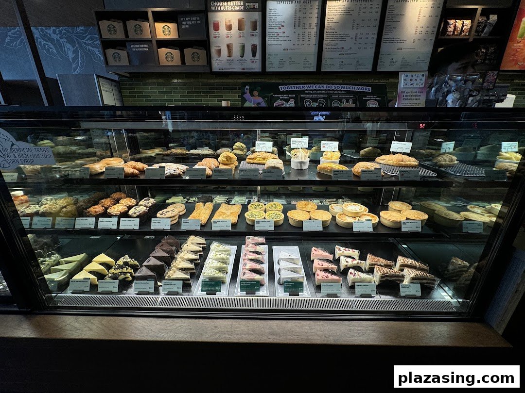 A vibrant display case showcasing a variety of pastries, cakes, and savory food items at Starbucks.