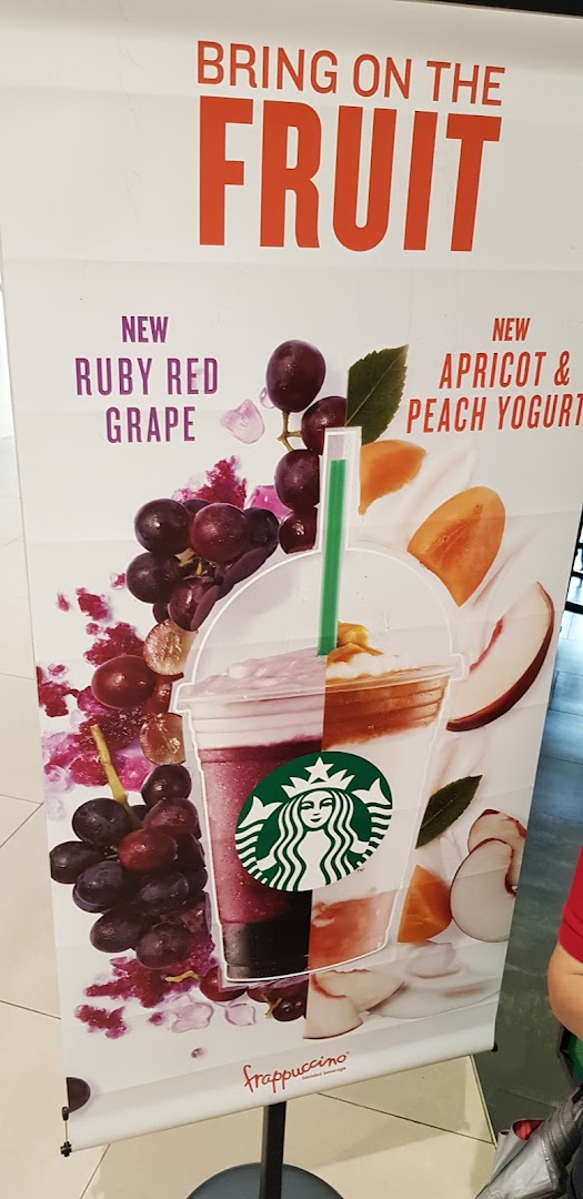 A Starbucks promotional banner showcasing new Ruby Red Grape and Apricot & Peach Yogurt Frappuccino flavors.
