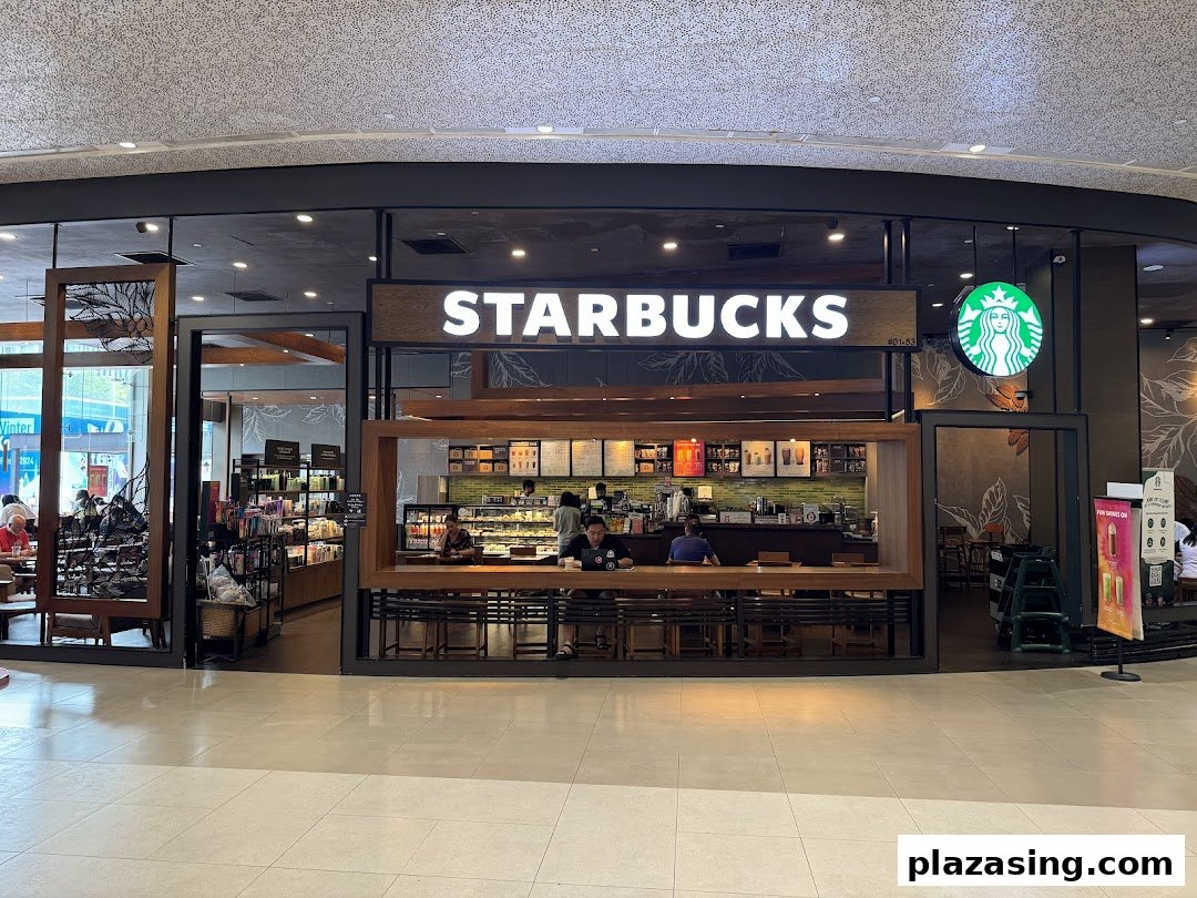 The inviting exterior of Starbucks Plaza Singapura, showcasing its entrance and interior seating area.