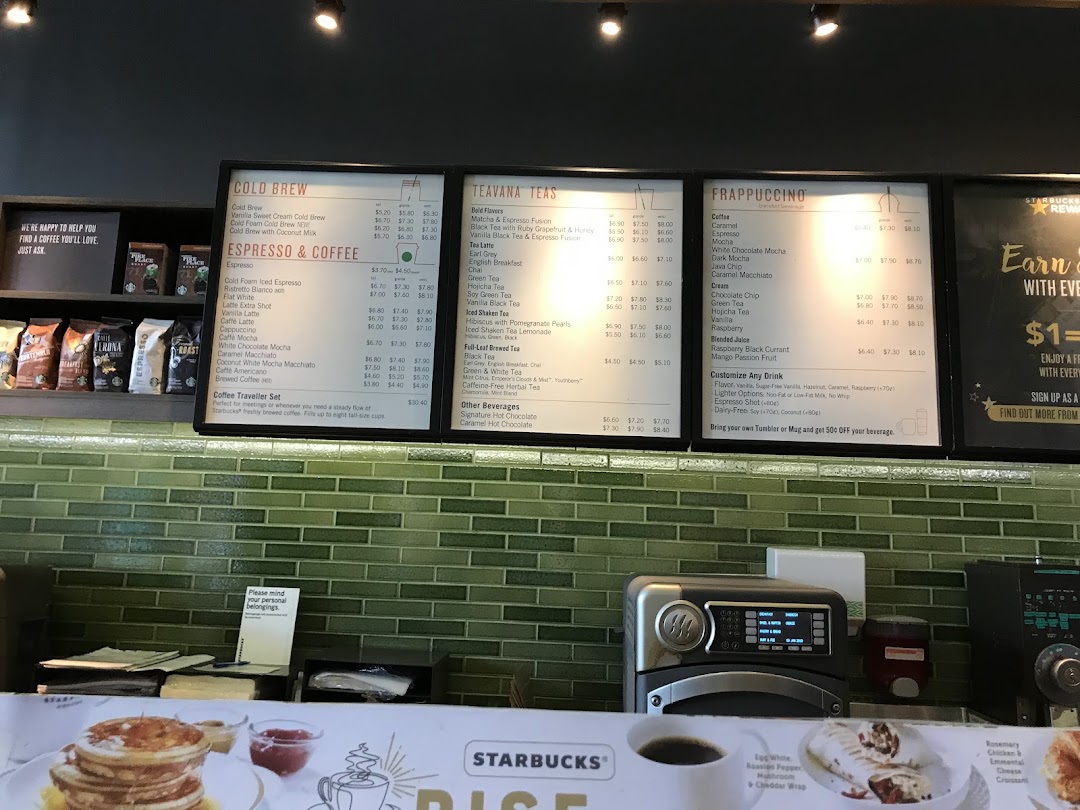 A detailed view of Starbucks' menu boards featuring coffee, tea, and Frappuccino selections.