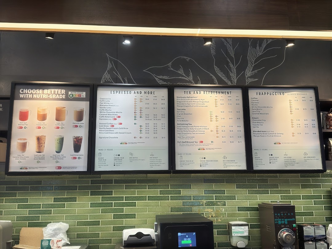 A comprehensive Starbucks menu board displaying various coffee, tea, and blended beverages with prices.