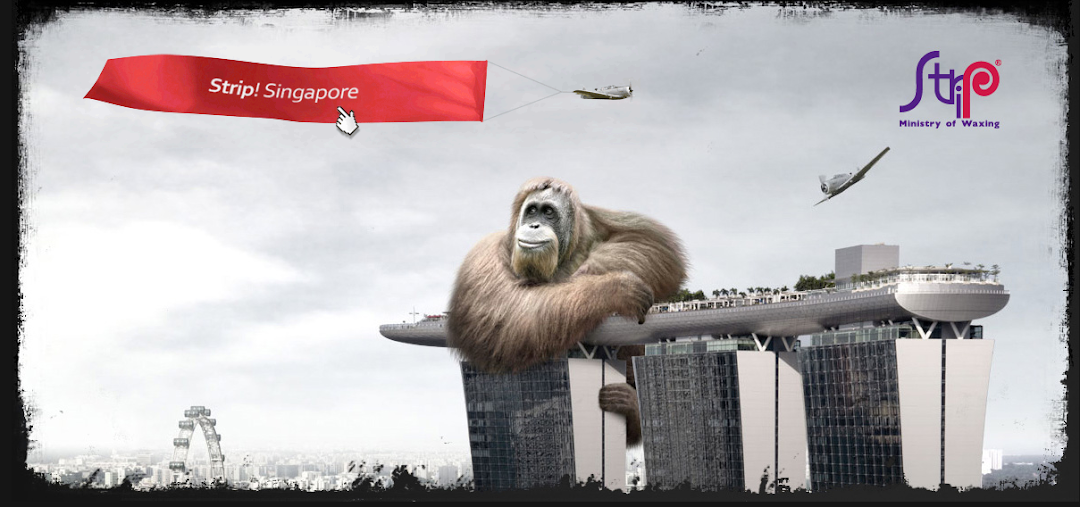 A giant orangutan sits atop Marina Bay Sands with a plane pulling a 'Strip! Singapore' banner.