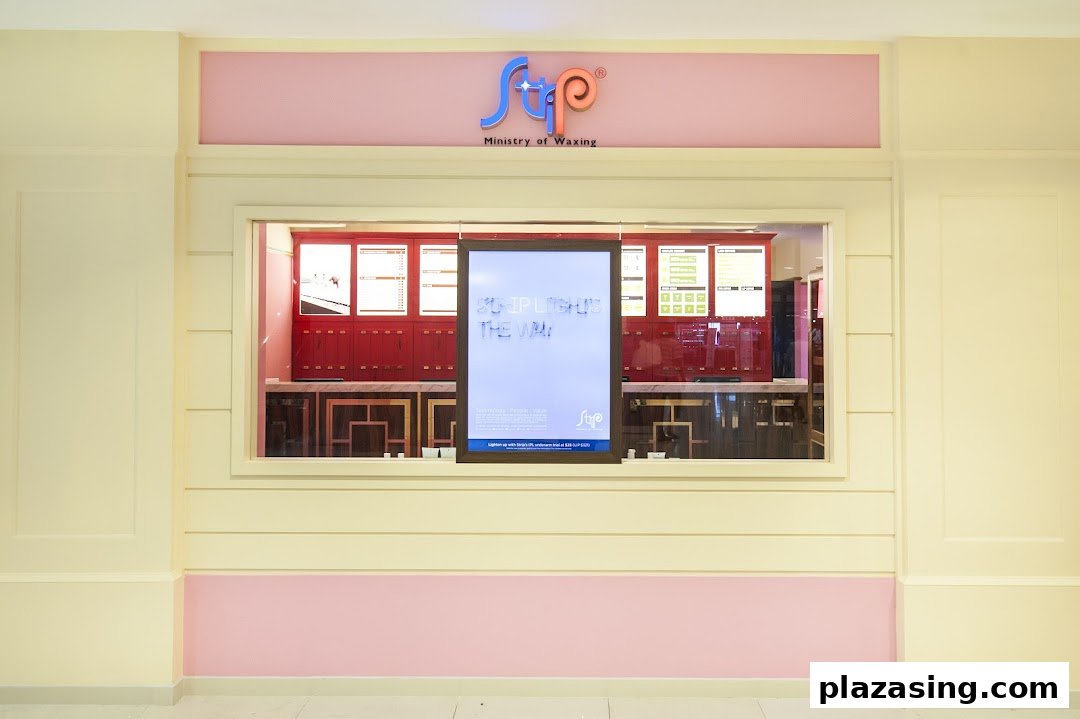 The storefront of Strip Co-Ed Plaza Singapura, a waxing salon, featuring its logo and a promotional display.