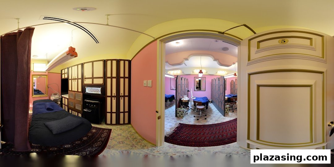 Interior view of Strip Co-Ed Plaza Singapura, showcasing private treatment rooms with beds and equipment.