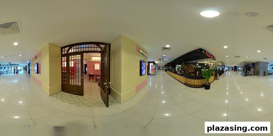 The elegant entrance of Strip Co-Ed, a beauty salon, within a brightly lit shopping mall corridor.