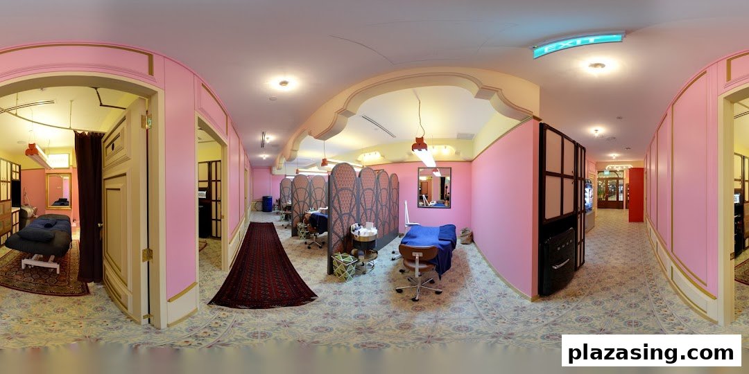 Interior view of a beauty salon with multiple treatment areas, pink walls, and patterned floors.