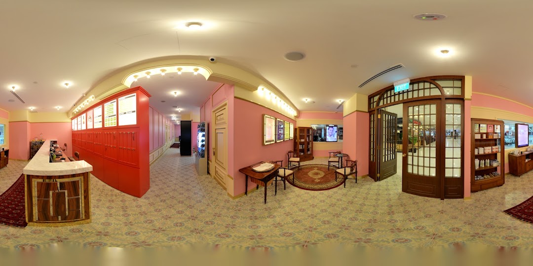 Interior view of Strip Co-Ed Plaza Singapura, featuring a reception desk, waiting area, and product displays.