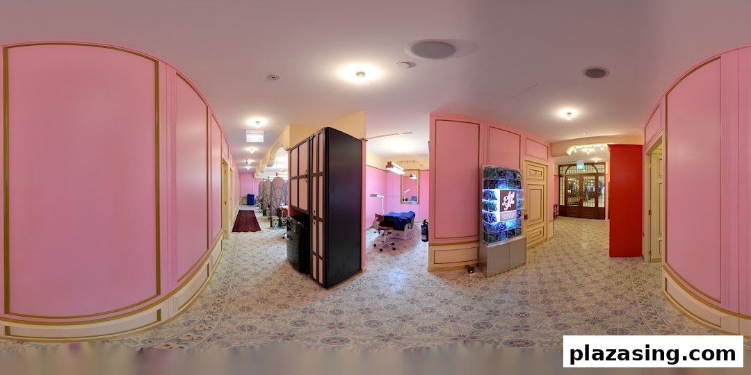 A vibrant pink and gold interior of a beauty salon with patterned floors and treatment areas.