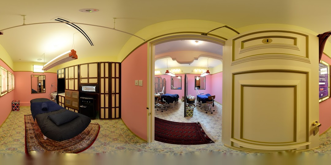 Interior view of a modern beauty salon with multiple treatment rooms and equipment.