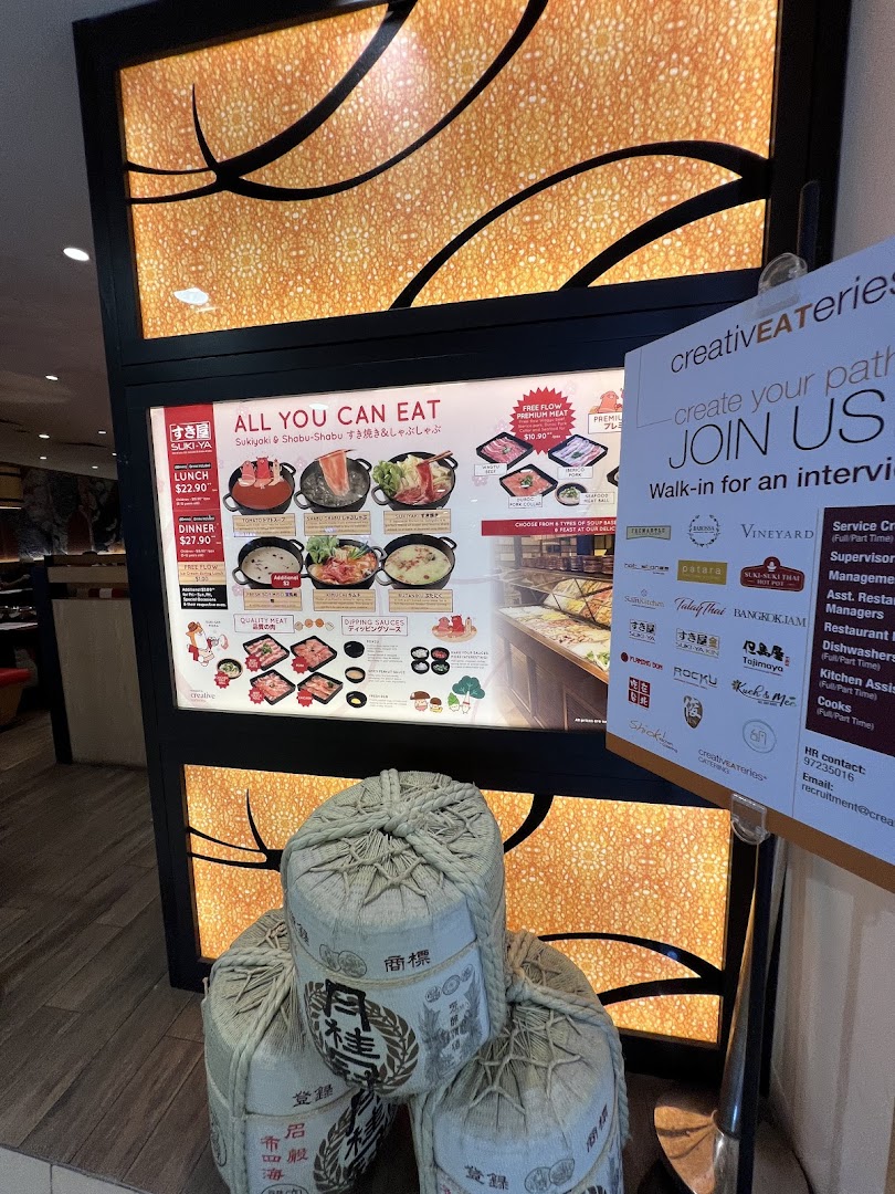 A brightly lit display board at Suki-Ya's entrance showcasing their all-you-can-eat shabu-shabu and sukiyaki offerings.
