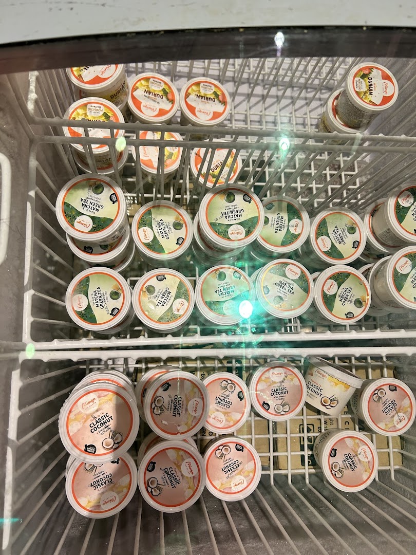 A freezer displays various Mingo brand frozen dessert cups: Durian, Matcha Green Tea, and Classic Coconut.