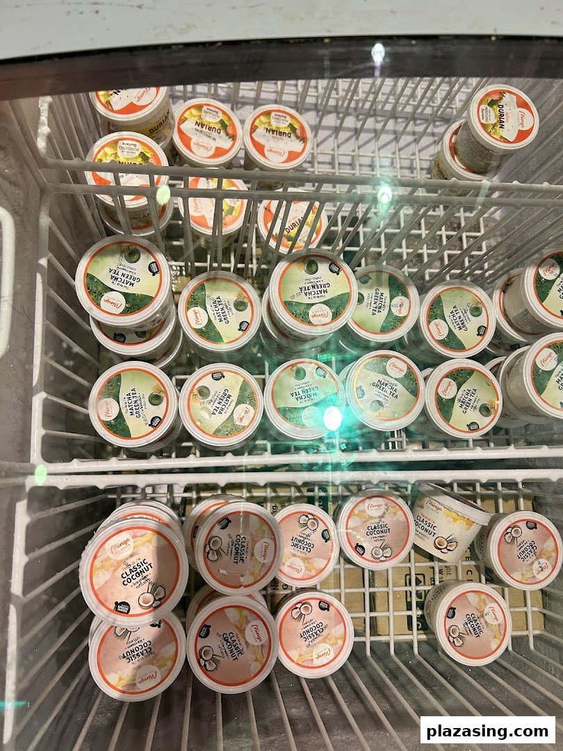 A freezer displays various Mingo brand frozen dessert cups: Durian, Matcha Green Tea, and Classic Coconut.