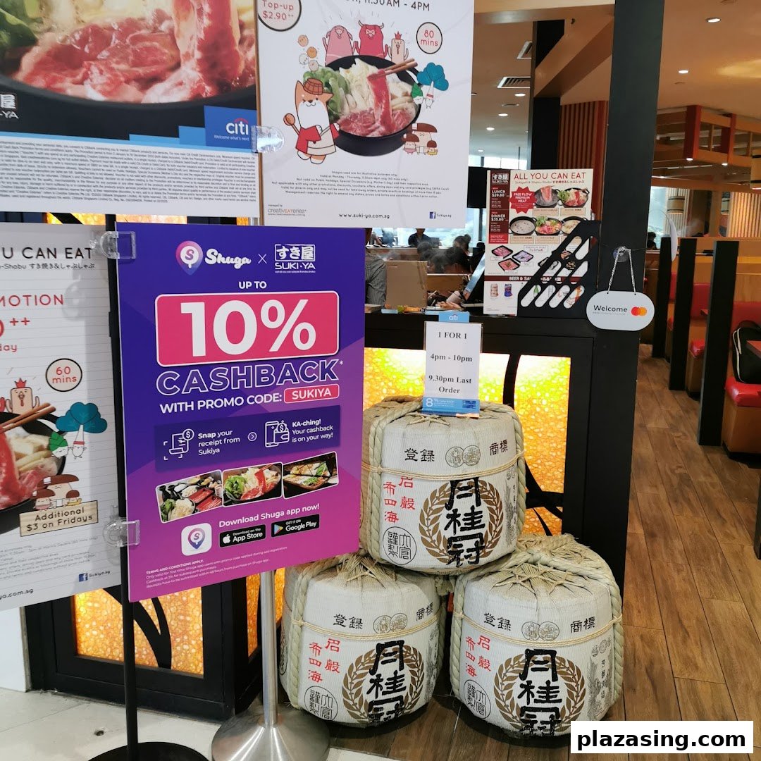 An interior shot of Suki-Ya, showcasing various promotional posters for all-you-can-eat shabu-shabu and cashback offers.