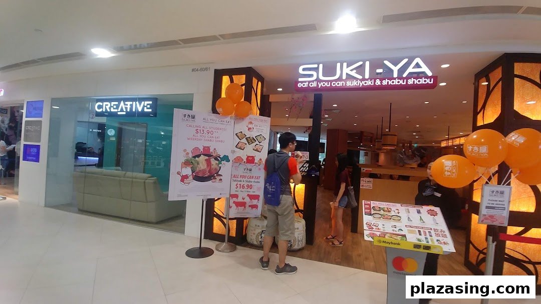 The entrance of Suki-Ya, an all-you-can-eat sukiyaki and shabu-shabu restaurant, with promotional posters.