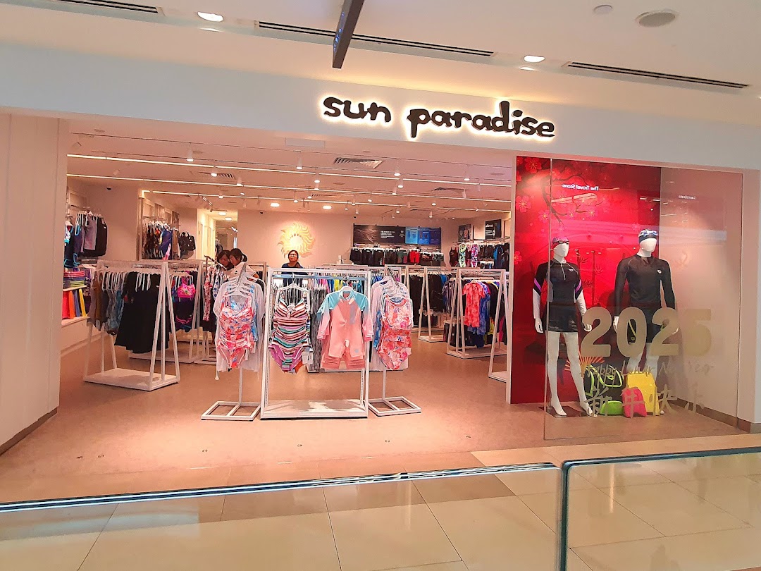 The brightly lit entrance of Sun Paradise, showcasing swimwear and activewear on display.